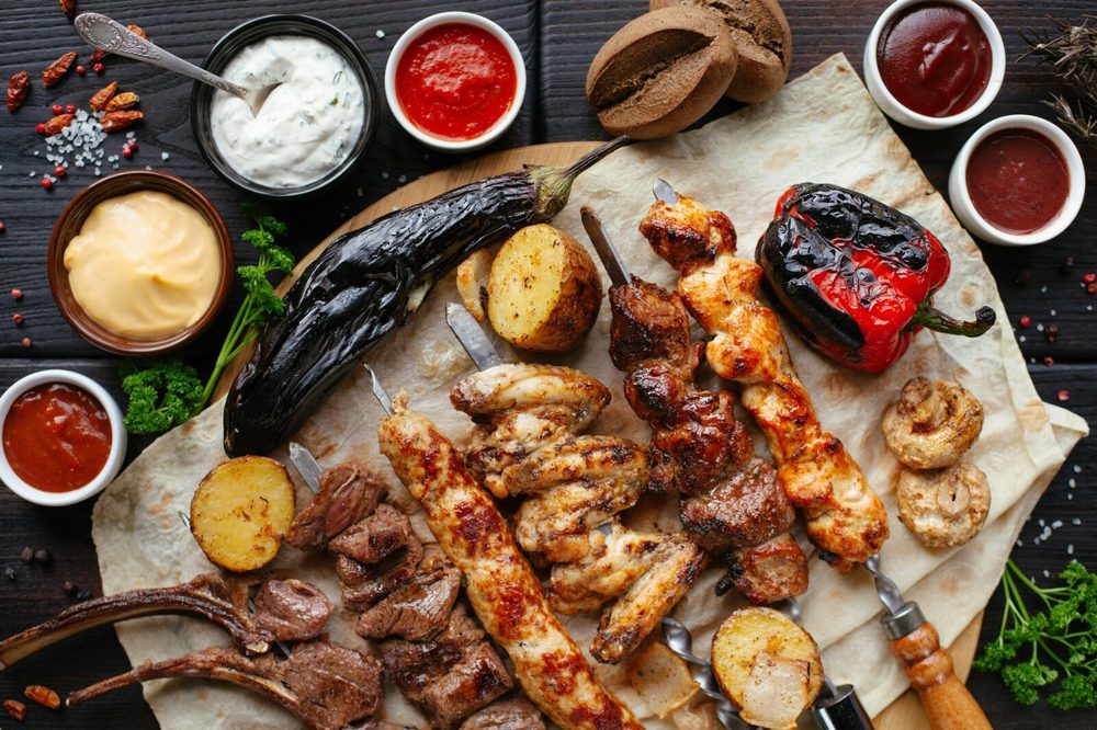 Grilled meats and vegetables served on flatbread